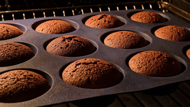 Muffins. Baking in oven. Time lapse footage of cooking cupcakes. Bakery concept