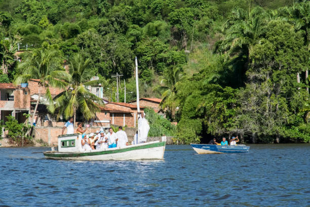 Cachoeira, Bahia, Brazil - February 21, 2016: Candombe members on a boat carrying gifts to Iemanja. City of Cachoeira, Bahia.