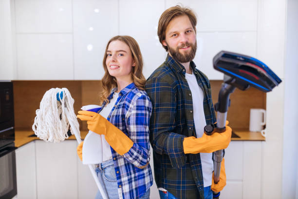 istock Cleaning is fun. Young couple dancing with mop and broom while s 1459778838