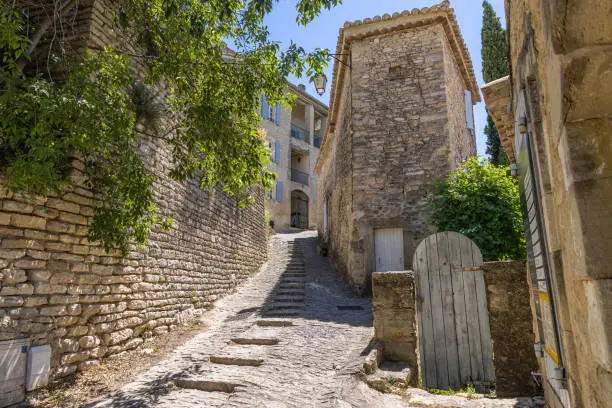 Gordes, Vaucluse, Provence-Alpes-Cote d'Azur, France. A steep narrow street in a small town in Provence.