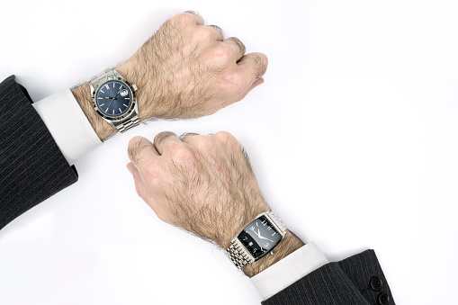 Business man showing the watch as meeting reminder concept