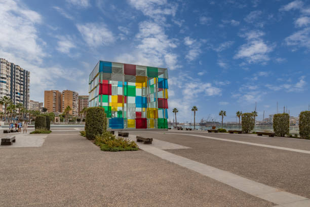 Centre Pompidou. Colorful glass cube in sunlight and amazing blue sky above, entrance to Centre Pompidou, located in renovated port area of Malaga