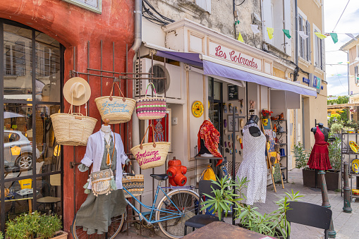 L'Isle-sur-la-Sorgue, Avignon, Vaucluse, Provence-Alpes-Cote d'Azur, France. July 6, 2022. Small shops in L'Isle-sur-la-Sorgue.
