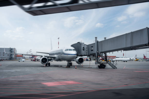istock Passenger airplane on the airfield docked with passenger boarding bridge 1459798003