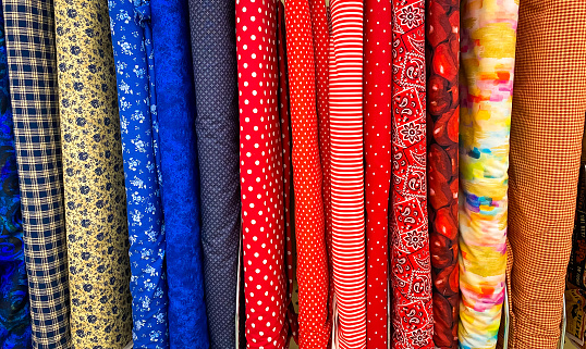 Bolts of colorful printed fabric.