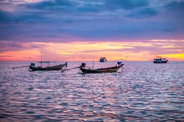 sunset in thailand. Koh tao island boats Thai Boats floating on water at sunset in front of Koh tao island koh tao thailand stock pictures, royalty-free photos & images