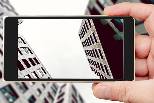 istock Buildings of modern city on smartphone screen. 1459802417