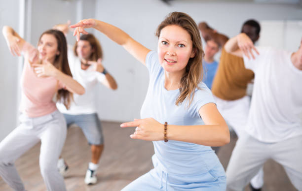 istock Cheerful female training position of hands before pair dance in studio 1459808670