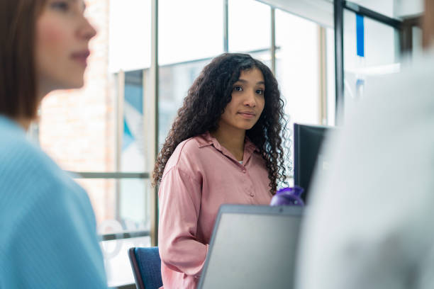 istock three latin women are inside the office where they work doing teamwork with the help of their laptop to share ideas 1459811913