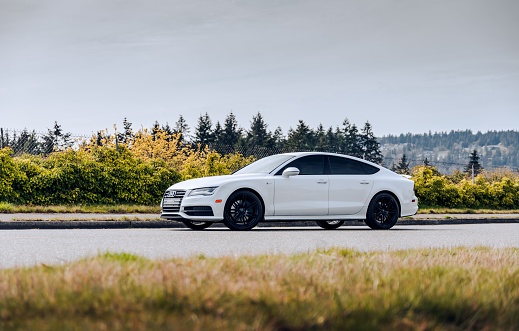 Tacoma, WA, USA\nJanuary 24, 2023\nWhite Audi A7 quattro parked showing the drivers side of the car with grass in the foreground