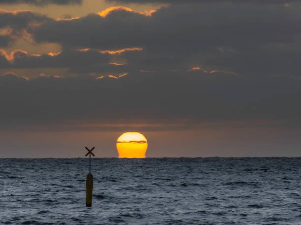 Sinking sun Sunset at St Kilda Beach Melbourne channel marker stock pictures, royalty-free photos & images