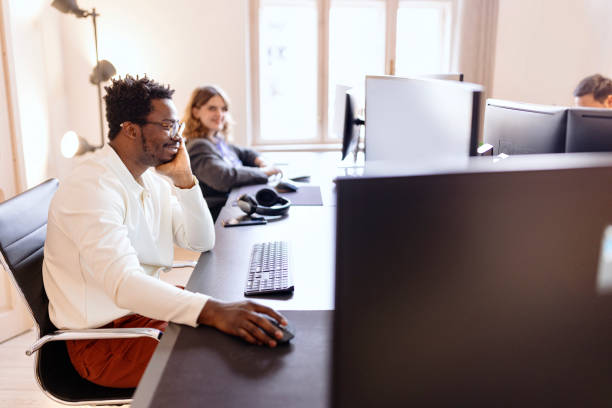 istock Man working in an open office with his creative design team 1459816188