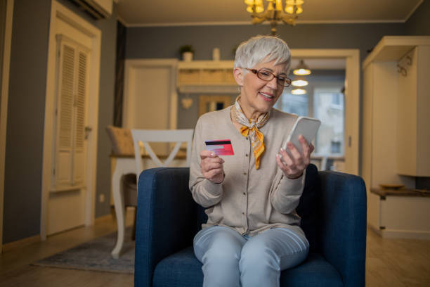istock Cheerful  woman doing online shopping 1459820427