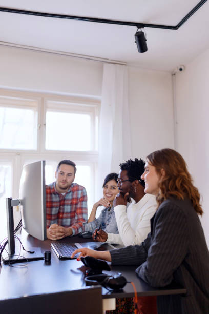 istock Four coworkers working at ergonomic standing desk in the office. 1459821902