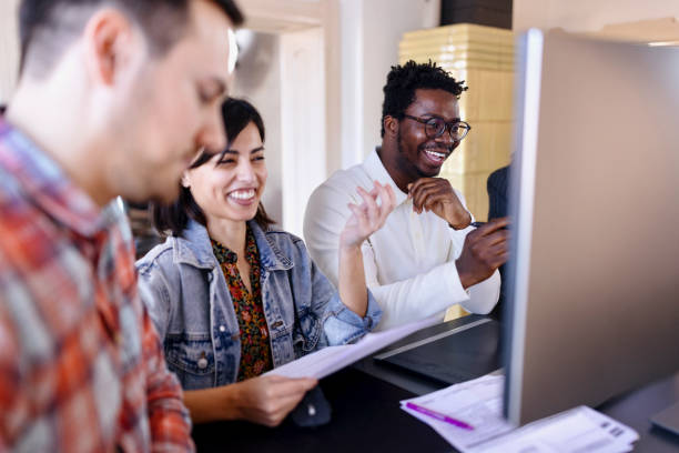 istock Four coworkers working at ergonomic standing desk in the office. 1459823014