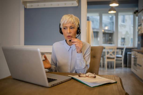 istock Senior woman working from home 1459827511