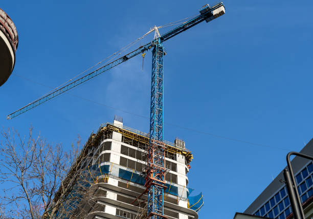 istock Construction site with cranes against blue sky. Industrial background. Modern skyscrapers. Unfinished construction 1459832248