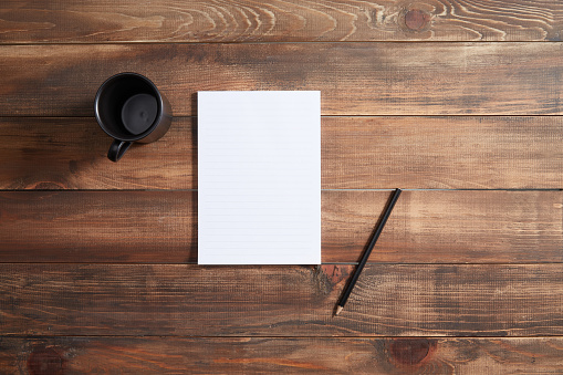 Empty paper with pencil and coffee on the table