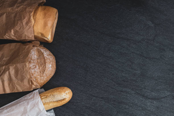 istock Two breads and one french baguette on a black background. 1459843332