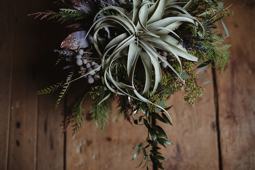 Wedding bouquet with succulents, berries and air plants