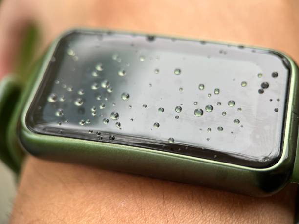 istock Water drop on smart watch screen worn by adult man 1459854036