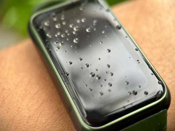 istock Water drop on smart watch screen worn by adult man 1459854066