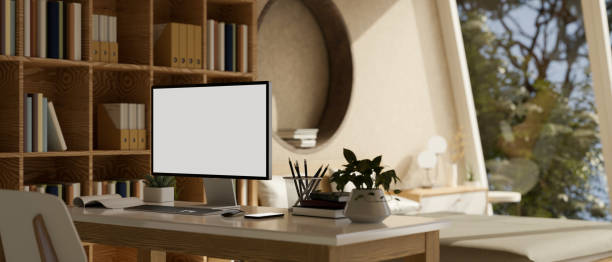 istock Home workspace with computer mockup on table in modern and cozy bedroom. 1459855556