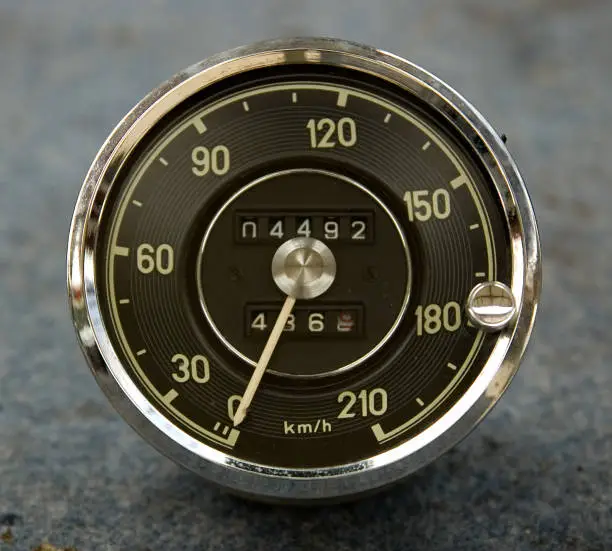 1960's Speedometer isolated over blue background. It is an European version in KPH.