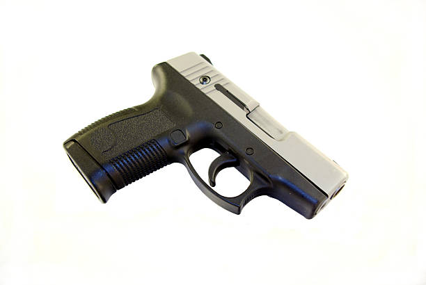 Semi Auto Pistol 45 caliber semi-auto pistol, black and stainless steel color on a white bcakground forty five caliber handgun stock pictures, royalty-free photos & images