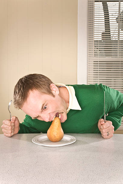 Man eating a pear stock photo