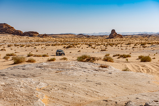 Drifting off road car 4x4 in desert. Freeze motion of exploding sand powder into the air. Action and leasure activity.