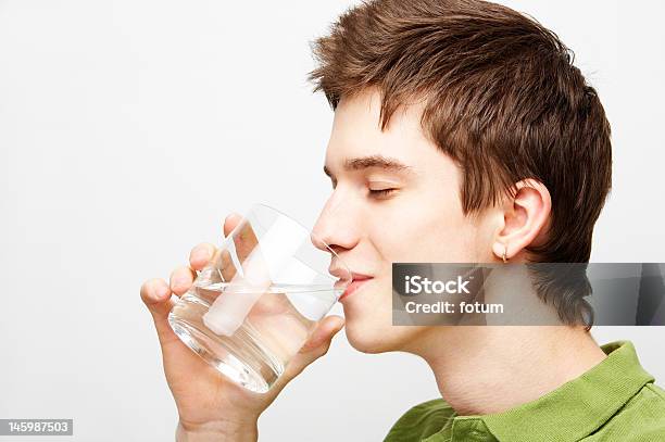 Young Man Is Drinking Mineral Water Stock Photo - Download Image Now - Adult, Adults Only, Beautiful People