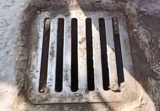 Drainage hatch on the street. View from above, top view.