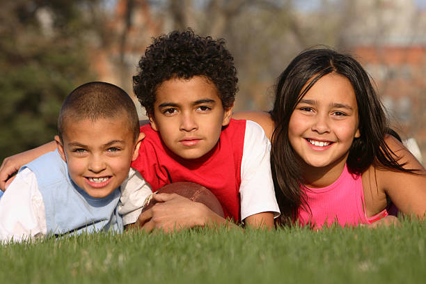 A photoshoot of three kids with different races  stock photo