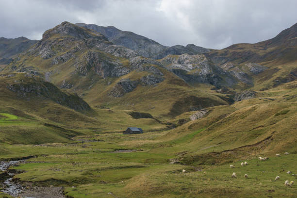 Landscape of Pyrenees Mountains with remote farm house building at the french and spanish border, Col du Pourtalet, Nouvelle-Aquitaine France stock photo