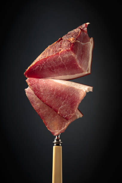 istock Dry-cured pork fillet on a fork. 1459883944