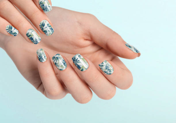 istock Beautiful female hands with light blue leaf manicure 1459885183