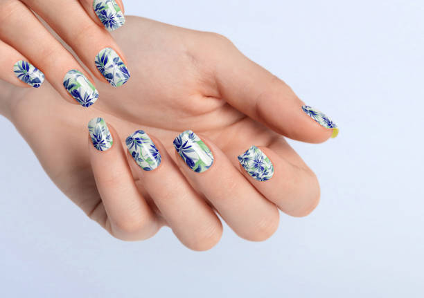 istock Beautiful female hands with dark blue leaf manicure. Female hands on copy space. 1459885189
