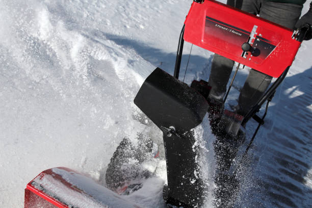 istock A man  is cleaning  snow from sidewalks with a snow blower after a snowstorm. 1459885354