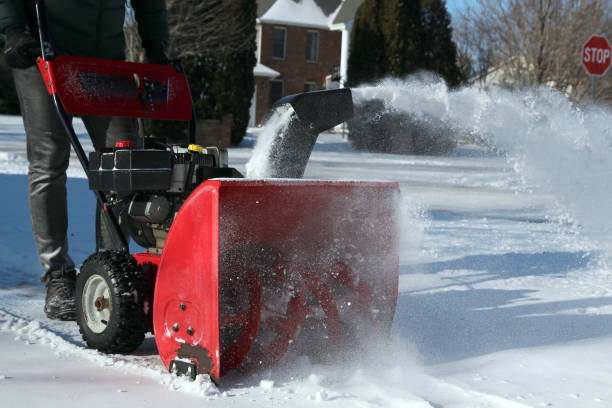 istock A man  is cleaning  snow from sidewalks with a snow blower after a snowstorm. 1459885502