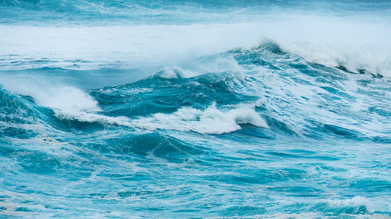Blue ocean waves abstract background. Rough sea water during stormy weather. Surface of sea wave splash