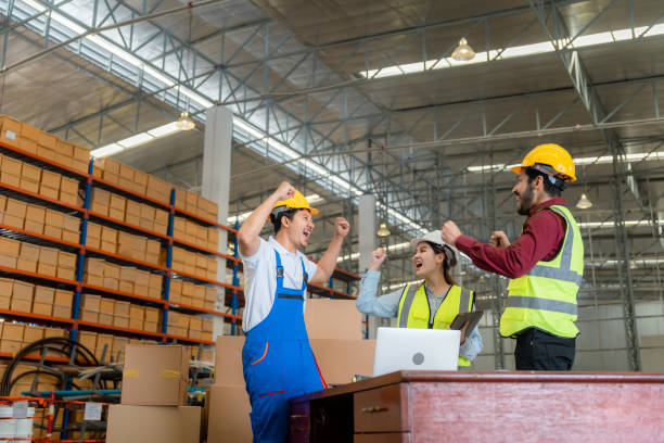 istock Happy employees celebrating together at warehouse 1459895042