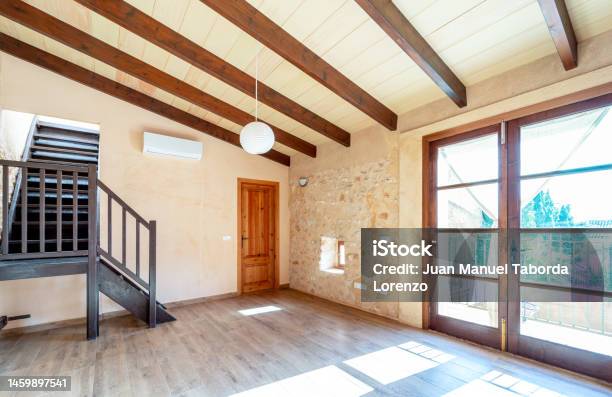 Open Plan Empty Master Bedroom With Parquet Floors Wooden Beams Balcony And Air Conditioning In Rustic Style Stock Photo - Download Image Now