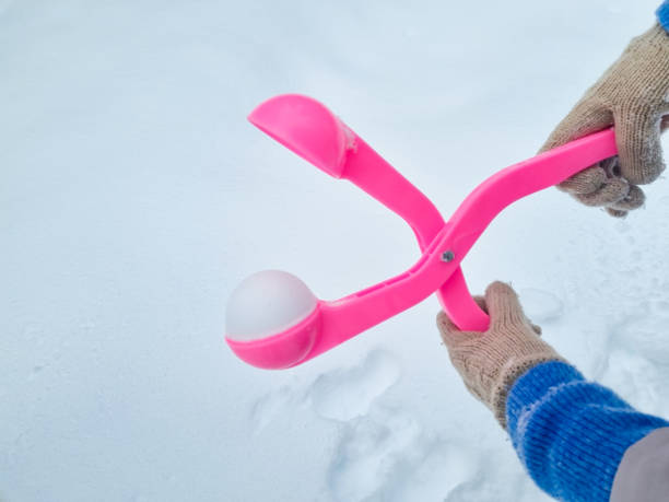 istock pink snowball maker make balls out of snow. 1459898272