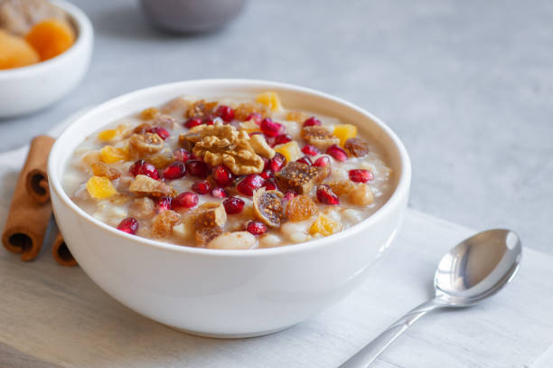 Traditional Turkish delicious mixed dessert, ashura (asure) with pomegranate seeds, walnut, apricot, Noah’s pudding stock photo