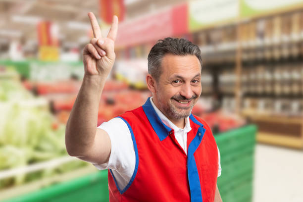 istock Smiling salesman showing peace sing 1459908732