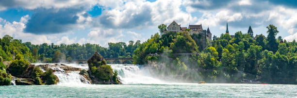 Rhine Falls waterfall in Schaffhausen, Switzerland seen from above with the Schloss Laufen next to the waterfall. The Rheinfall in the river Rhine is the most powerful waterfall in Europe.