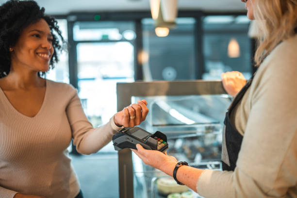 istock Hispanic Female In A Cafe Paying With A Smart Watch 1459914864