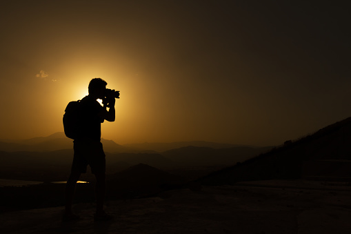 Silhouette of photographer, backlight at sunset in Andalusia (Spain). High contrast photo with room for text / negative space