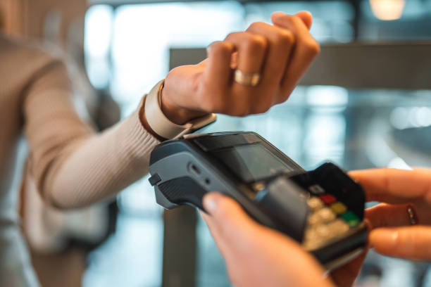 istock Hispanic Female In A Cafe Paying With A Smart Watch 1459914967